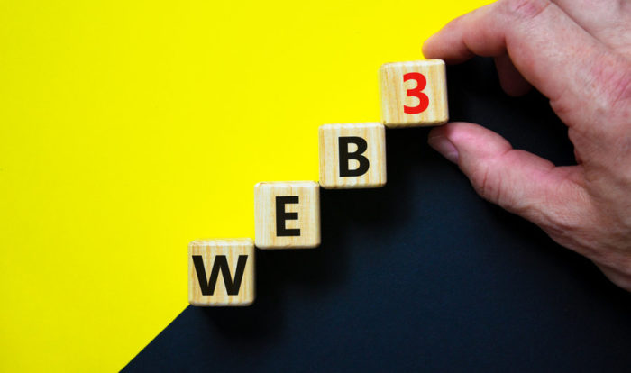 WEB3 or web 3 symbol. Wooden cubes with concept words WEB 3. Beautiful yellow and black background, copy space. Businessman hand. Business, technology web3 and WEB 3 or 3.0 concept.