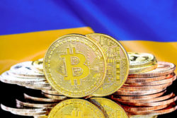Bitcoins on Ukraine flag background